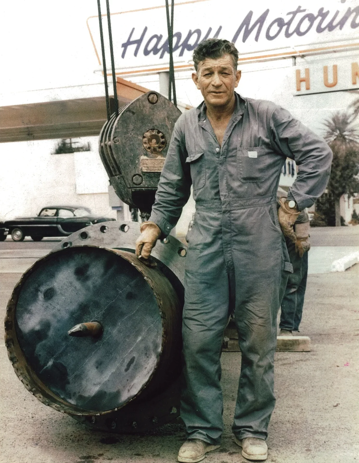 Melvin Coker standing beside historic hot tap equipment