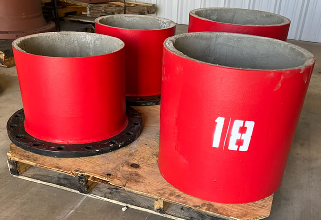 Red fabricated Koppl components for concrete pressure pipe