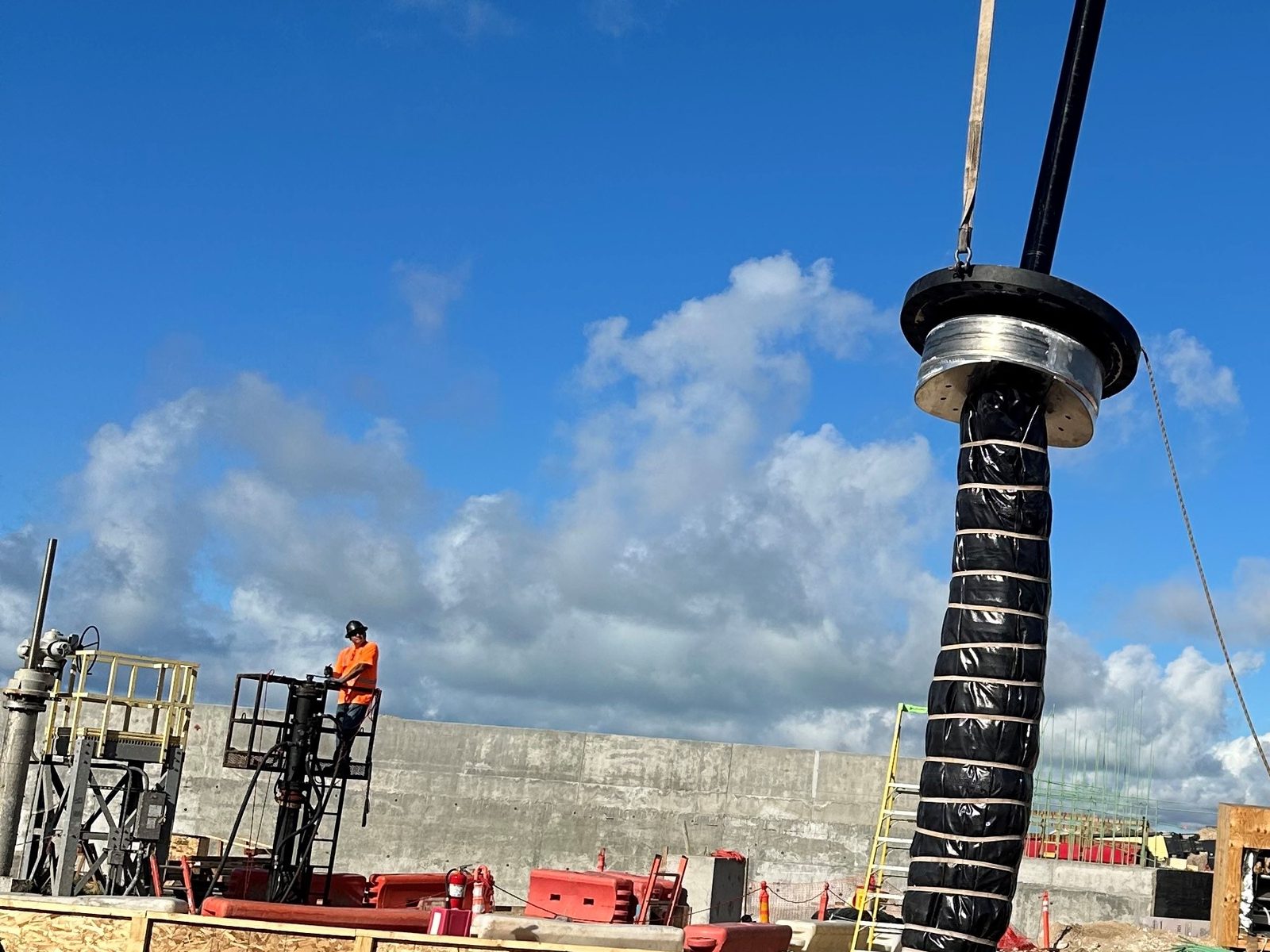 Crane lifting an 84-inch bag line stop assembly out of the line